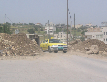 Villagers removed the dirt pile blocking road between the villages of al-Funduq and Hajja removed by the villagers. Photo: Raaed Moqdi, B'Tselem, 13 April 2008.