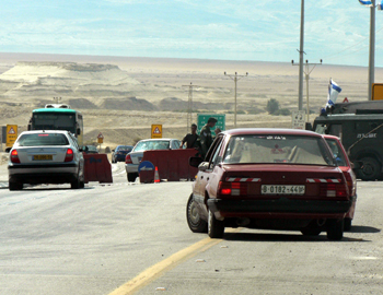 Almog/Beit Haarava Checkpoint. The photo, taken on 8 June 2008, a few days after the army announced it had removed the checkpoint, shows a Palestinian vehicle stopped on the road while Israeli vehicles pass through the checkpoint. Photo: Firas &lsquo;Alami, The Association for Civil Rights in Israel.