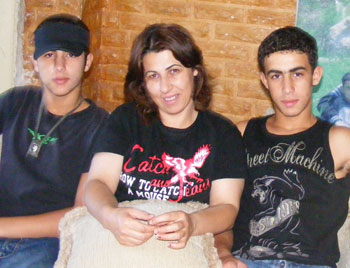 Fidaa Abu 'Aqer and two of her sons. Photo: Suha Zied, B'Tselem.