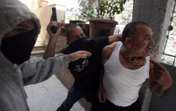 Undercover policemen hold al-Atrashâ€™s father during the incident. Photo: Baz Ratner, Reuters