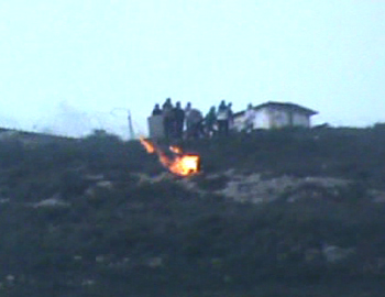 Settlers roll burning tires from the Yitzhar settlement to the Palestinian villages Burin and 'Einabus below. Footage: B'Tselem camera project, 28 Feb. '11. 