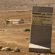 Military firing-zone sign placed at the entrance to the small Palestinian community of al-Hadidiyeh, in the Jordan Valley. Similar signs have been posted near other Palestinian communities in the Valley. Photo: Activestills, 13 July 2009