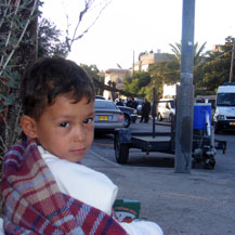 Tamer al-Ghawi sitting in the street after his family was evicted from their home in Sheikh Jarah, East Jerusalem. Photo: Kareem Jubran, B'Tselem, 5 Aug. '09.