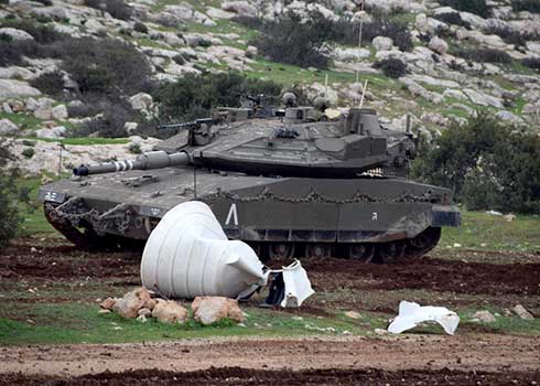 Military tank next to a trampled water tank in Khirbet Ibzik. Photo by 'Araf Daraghmeh, B'Tselem, 28 Dec. 2021