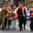 <p>[6646] 21  Israeli ambulance workers help a wounded victim of a suicide bombing in Jerusalem on March 21, 2002. A Palestinian suicide bomber killed three people and wounded more than 40 on a busy Jerusalem shopping street.</p><p>Photo credit: Tsafrir Abayov, © Reuters</p>