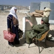 <p>[1769] 12  An Israeli soldier stops a Palestinian woman attempting to cross the Qalandiya checkpoint on the road from Ramallah to Jerusalem.</p><p>Photo credit: Mahfouz Abu Turk, © Reuters</p>