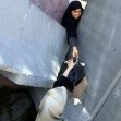 <p>[5947] 19  A Palestinian woman passes goods through a gap in a concrete barrier separating Arab East Jerusalem from the rest of the West Bank, May 19, 2003.</p><p>Photo credit: Mahfouz Abu Turk, © Reuters</p>