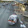 <p>[899] 9  Bodies lie on stretchers next to an ambulance at the scene of a bombing outside the Tzrifin army base near Tel Aviv on September 9, 2003.</p><p>Photo credit: Eliu, © Reuters</p>
