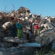 <p>[2762] 4  Children standing on the rubble of their home which was demolished to build the Separation Barrier in Jerusalem.</p><p>Photo credit: Yehezkel Lein, B'Tselem</p>