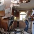 <p>[8639] 25  Members of an Israeli family survey their damaged house following a Qassam rocket attack in the city of Sderot, southern Israel.</p><p>Photo credit: Amir Cohen, © Reuters</p>
