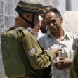 <p>[9963] 5  Soldier checks the identity card of a Palestinian, near Nablus.</p><p>Photo credit: Oleg Popov, © Reuters</p>