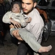 <p>[9969] 1  A paramedic carries a girl after an Israeli missile struck a house in Gaza</p><p>Photo credit: Mohammad Salem, © Reuters</p>