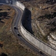 <p>[10641] 12  Military vehicles drive beside a concrete wall, part of Israel's controversial security barrier in Abu Dis, on the edge of Jerusalem June 12, 2008.</p><p>Photo credit: Eliana Aponte, © Reuters</p>