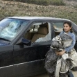 <p>[10105] 16  Lena 'Afaneh next to her father's car, which he says was destroyed by settlers while his family was picking olives on land of the village 'Azmut, Nablus District. </p><p>Photo credit: Salma a-Dib’i, B'Tselem</p>