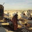 <p>[10639] 4 Febr A Palestinian woman walks past tents near her destroyed house in Jabalya, in the northern Gaza Strip, February 4, 2009. Thousands of Palestinians are living in tented camps after Israel's three-week assault on the Gaza.</p><p>Photo credit: Mohammad Salem, © Reuters</p>
