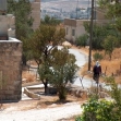 <p>[806] 15  The village of Nu'man, which is in Jerusalem but residents have West Bank IDs so they are "illegally in Israel" when in their own homes. A roadblock prevents access to Jerusalem and the Separation Barrier will block access to the West Bank.</p><p>Photo credit: Ofir Feuerstein, B'Tselem</p>