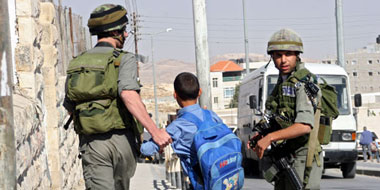 Border policeman detains youth in &lsquo;Anata, 29 October 2005. Photo: Anne Paq, Activestills.org