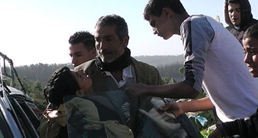 Samir 'Awad being evacuated from the scene after being shot. Photo: Nasar Mghar