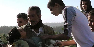 Samir &lsquo;Awad being taken to hospital. Photo: &lsquo;Abd a-Naser Murar, 15 January 2013.