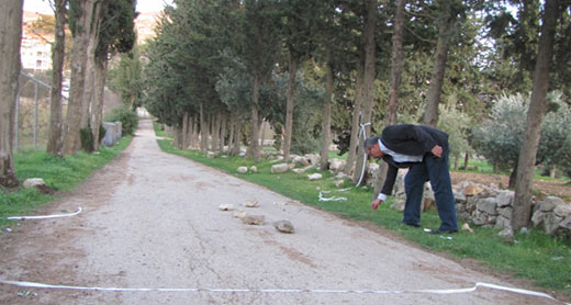 B’Tselem field researcher Iyad Hadad examines the scene of the incident. Photo by Musa Abu Hashhash, B’Tselem, 23 Jan. 2013