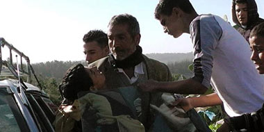 Samir &lsquo;Awad being evacuated from the scene after being shot. Photo: 'Abd a-Nasser Murar