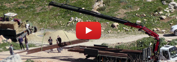Still from video: Civil Administration confiscating Yarza's water pipes, filmed by 'Aref Daraghmeh, B'Tselem
