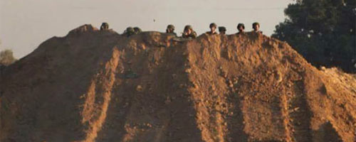 Soldiers watch protesters on other side of perimeter fence separating Israel and the Gaza Strip. Photo taken by demonstrators on 6 Nov. 2015