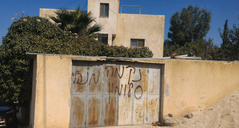 Graffiti sprayed painted by settlers on the front wall of Wasim Bader’s house at Um Safa. Photography: Iyad Hadad, B’tselem . 9.8.17 Graffiti sprayed painted by settlers on the front wall of Wasim Bader’s house at Um Safa. Photography: Iyad Hadad, B’tselem . 9.8.17