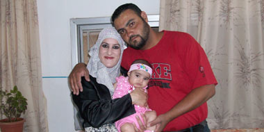 Rashad Shawakhah, killed by undercover soldiers in the village of Ramun, in a family photo with his wife Taghrid and their daughter