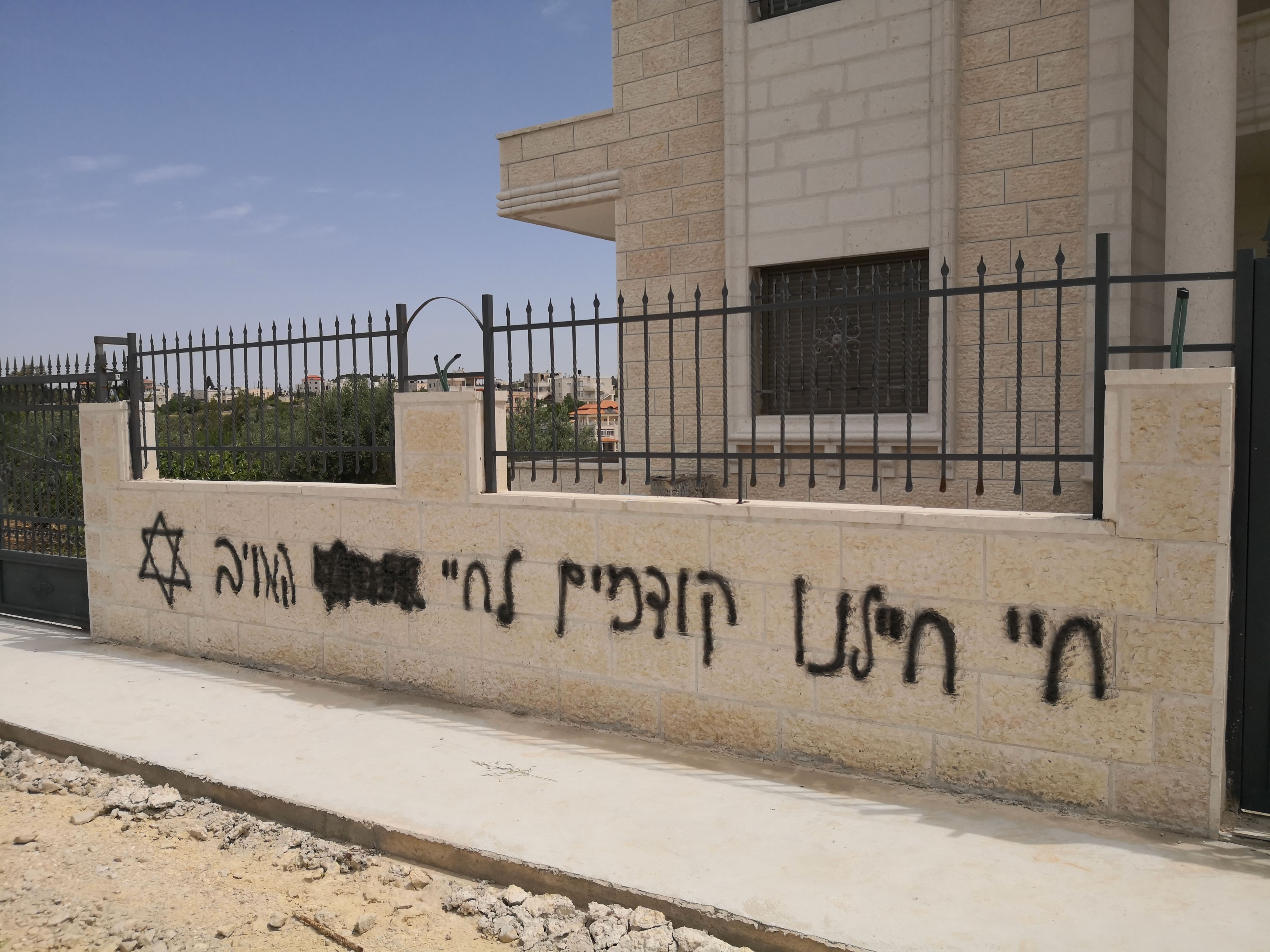 Hate graffiti sprayed on a house wall in Beitin, 13 May 2020