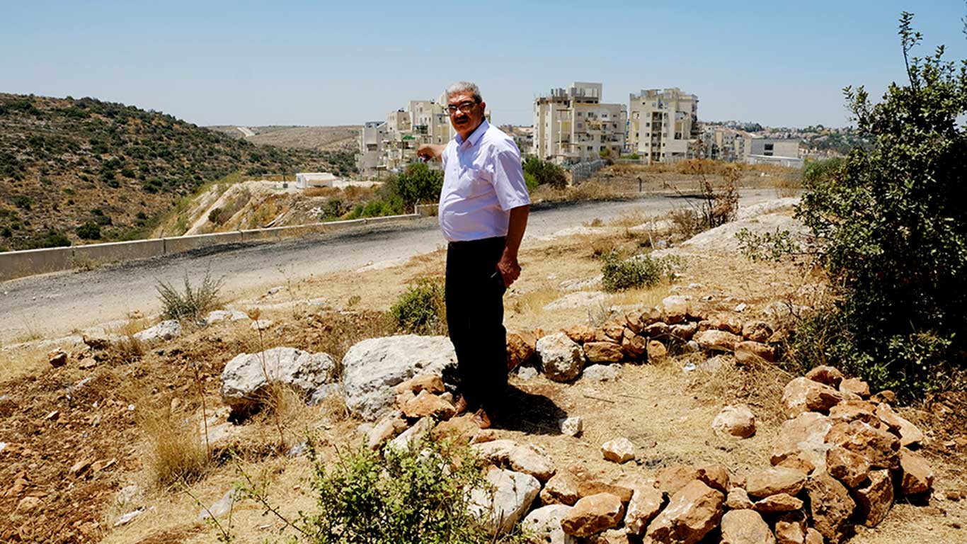 B’Tselem field researcher Iyad Hadad stands at the spot where Islam Dar Nasser was shot and points to the cluster of trees under which the tent stood. Photo by Alex Levac, 29 May 2021