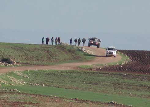 Residents evacuate from Ibzik escorted by the Civil Administration and the military. Photo by ‘Aref Daraghmeh, B’Tselem, 15 Dec. 2021 