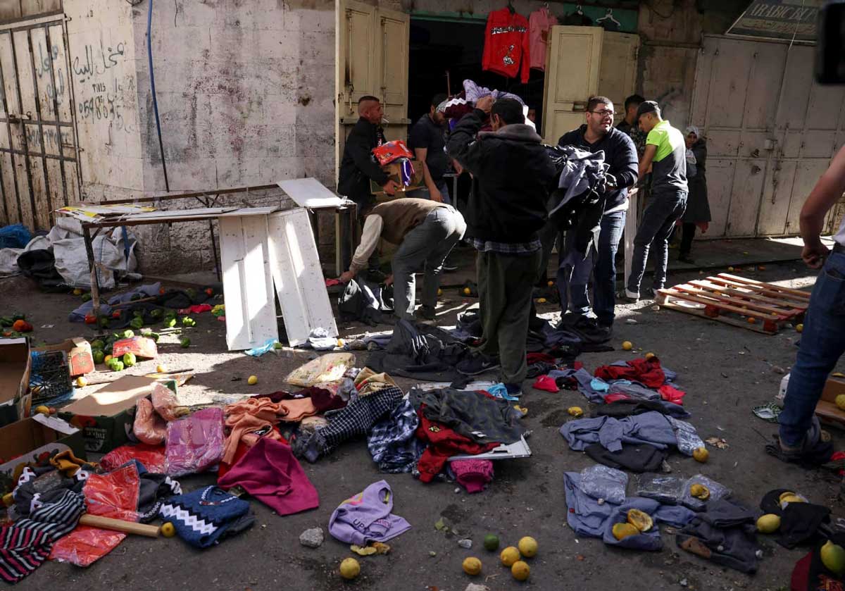 Palestinians try to gather merchandise that settlers scattered by Ahmad ‘Awawdeh's store,&nbsp;19&nbsp;Nov.&nbsp;2022
