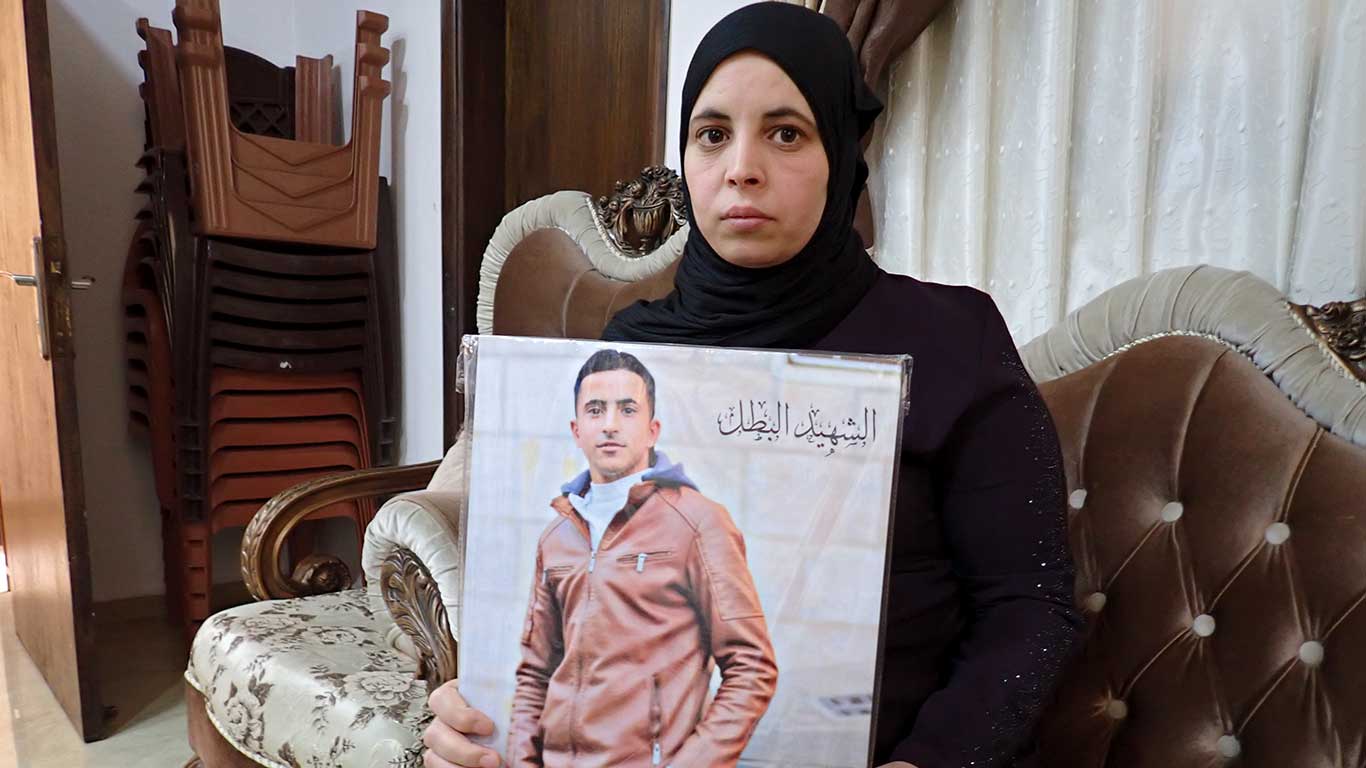 Munirah Sabah with a picture of her son. Photo by Manal al-Ja’bari, B'Tselem, 16 June 2023 