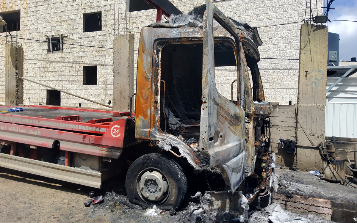 A truck parked on the street after being torched by settlers. Photo by: Salma a-Deb’i, B’Tselem. 