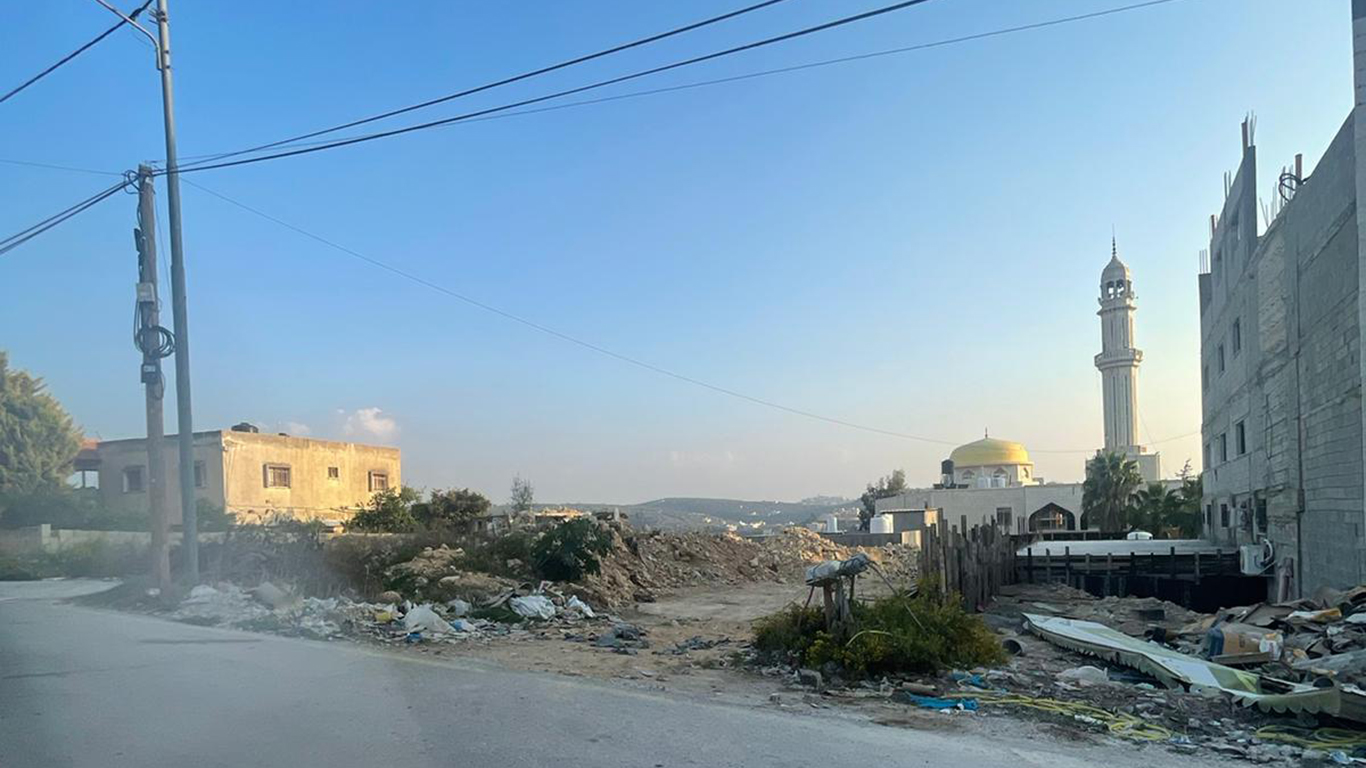 Right: The Mushref building under construction. Left: The mosque and the area from which the soldiers shot at the young men. Photo courtesy of a village resident
