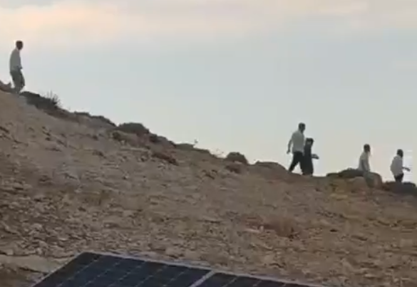 Settlers on Sawakrah's land a day before he and his flock were attacked. Still from video by community resident  
