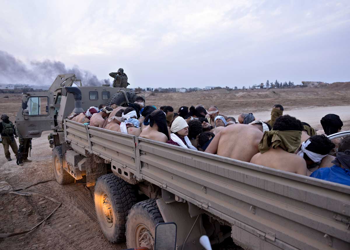 Hadil a-Dahduh Zaza led in a military truck with dozens of men on 6 Dec. 2023. Photo by Moti Milord, Haaretz