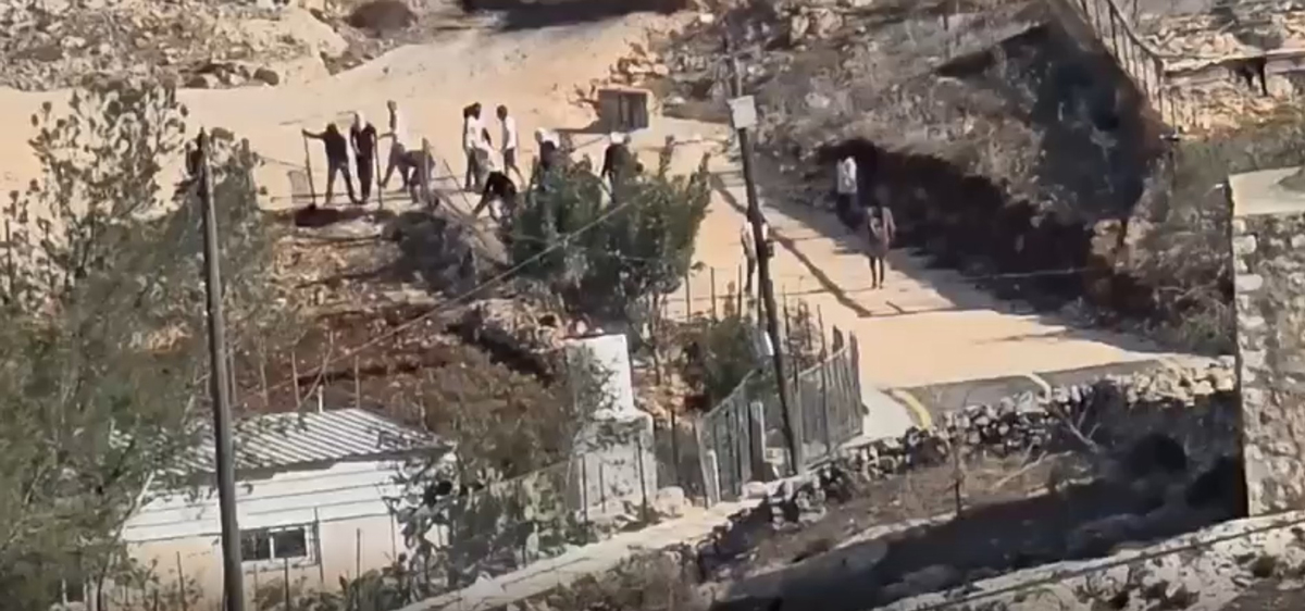 Settlers damage one home’s fence. Courtesy of a video provided by residents