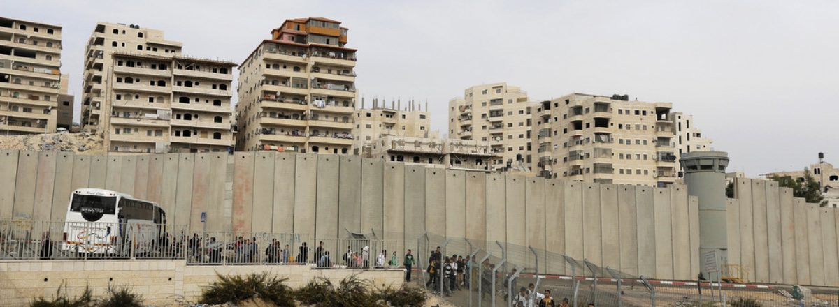 Palestinian children from Shu'fat refugee camp walk towards an Israeli checkpoint on their way to schools in other parts of East Jerusalem
