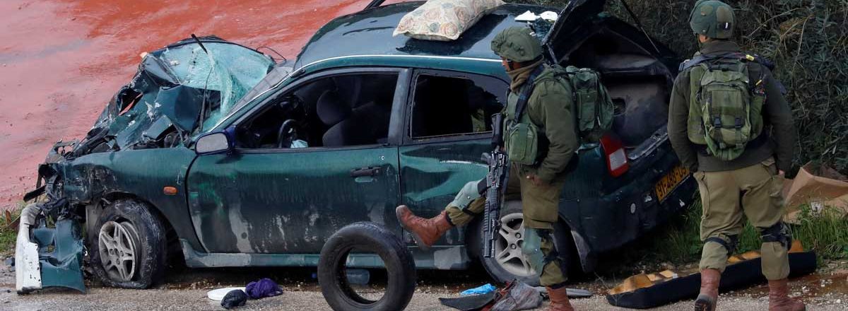 Soldiers by the car which collided with the military vehicle at Kafr Ni’ma. Photo by Mohammed Torokman, Retuers, 4 March 2019