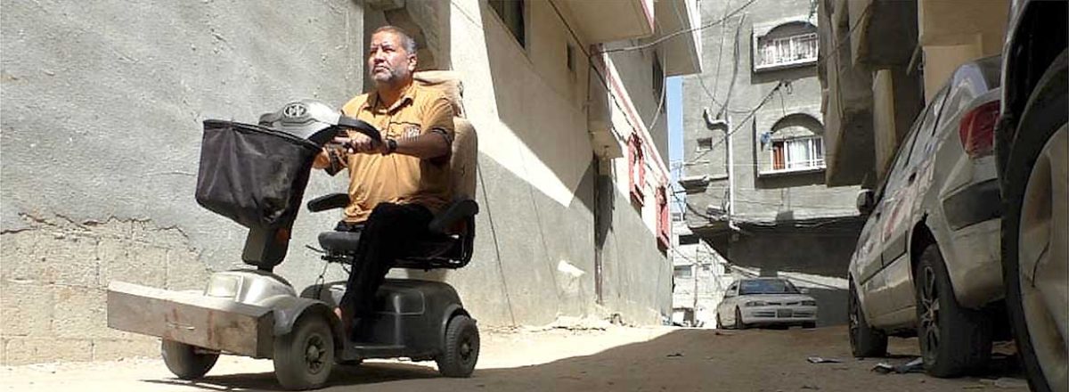 ‘Abd a-Rahman al-‘Ar’ir on the scooter he depends on to get around. When the power is out, he can’t charge it or leave home. Photo by Muhammad Sabah, B'Tselem.
