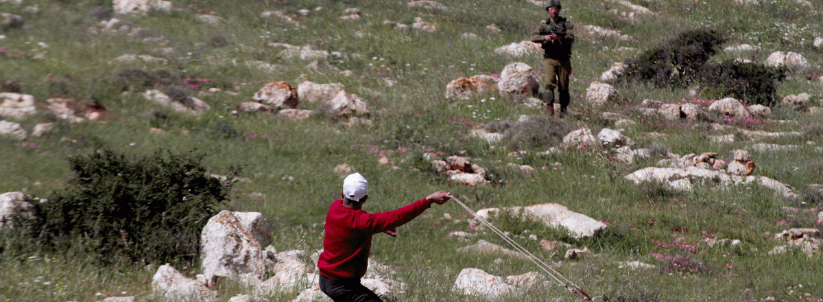 ‘Atef Hanayshi facing an officer on the hill where he was shot. Photo by Nedal Eshtayah, Anadolu Agency, 19 March 2021