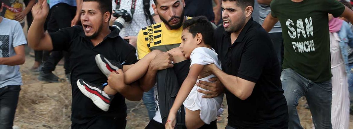 شبان يحملون المصاب عمر أبو النيل وينقلونه لتلقي العلاج بعدما أطلق الجنود الرصاص عليه وأصابوه في رقبته. تصوير: عبد الرحيم الخطيب