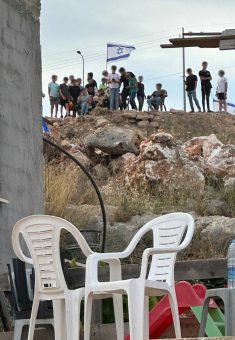 Settlers sitting in Mustafa Khater’s yard. Photo courtesy of the witness