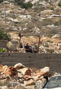 Settlers sitting in Mustafa Khater’s yard. Photo courtesy of the witness