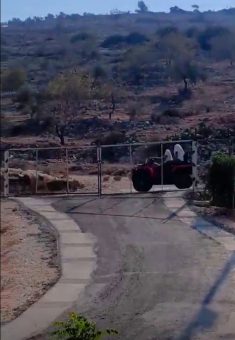 Settlers arrive at the village on an ATV. Courtesy of a video provided by residents