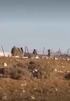 Settlers in Khallet a-Sidrah, photographed from afar by residents who fled