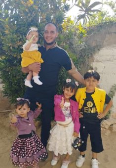 Nassim a‑Radi’ with his children before the war. Photo courtesy of the witness