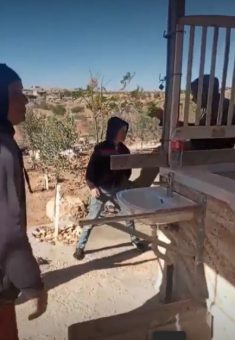 A settler kicking ‘Abdallah, 13. Still from video footage, courtesy of the family 